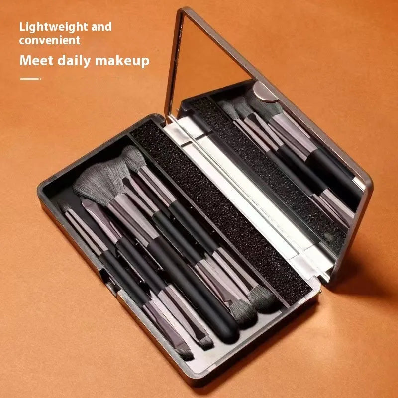 Silver and gold makeup brush sets in a case with a mirror, showing artificial fibre bristles.