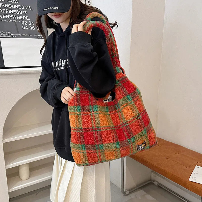 Women's plaid plush crossbody tote bag showing large capacity interior with zipper compartments
