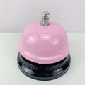 Iron game bell in assorted colours including red, blue, green, pink, and yellow for service or classroom use.