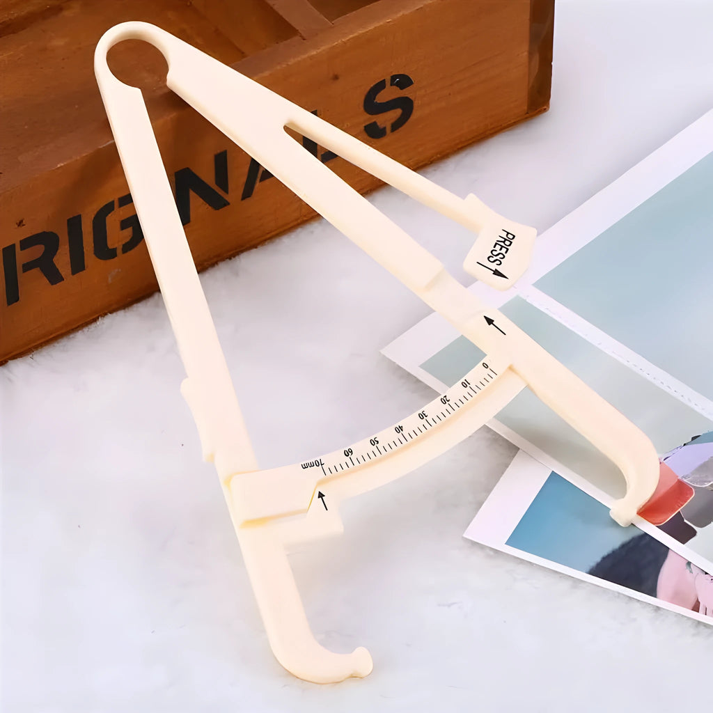 Compact acrylic fat caliper for body fat measurement, showing size and scale.