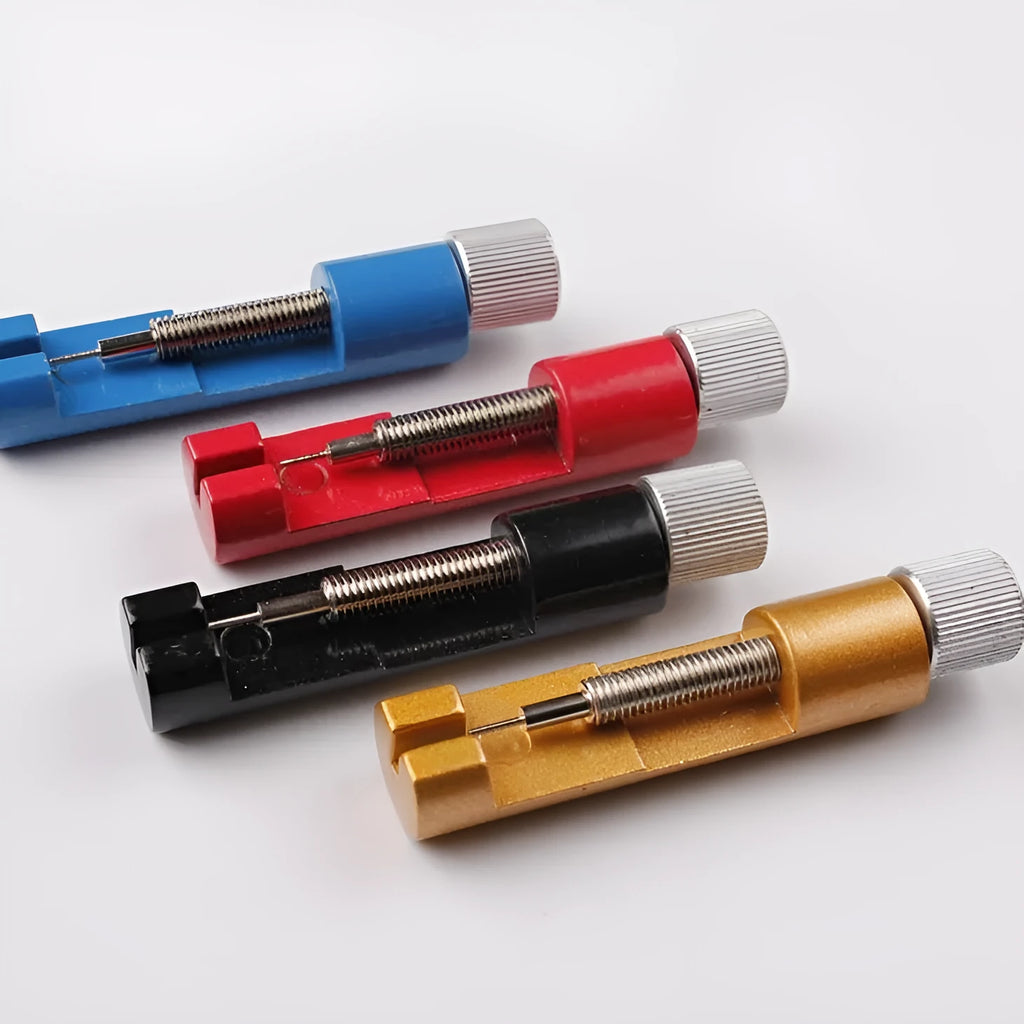 Watch strap link remover tool in black with two thimbles and a metal watch band placed on the detacher groove