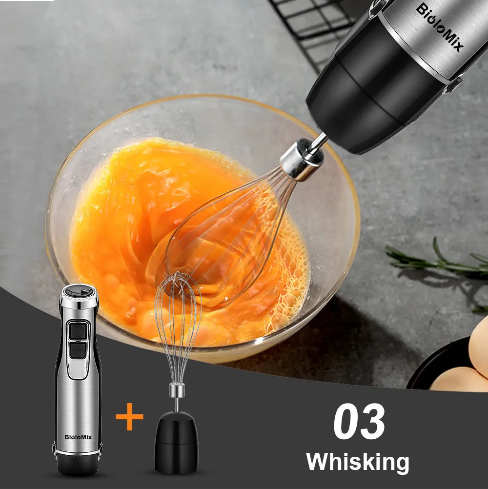 Silver Biolomix hand blender kit with motor unit, stainless steel shaft, whisk, chopper bowl, and blending beaker.