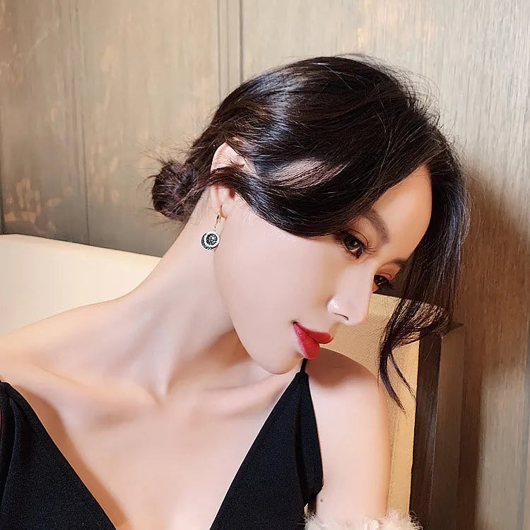 Black geometric round alloy drop earrings with 3.6cm length on a white background.