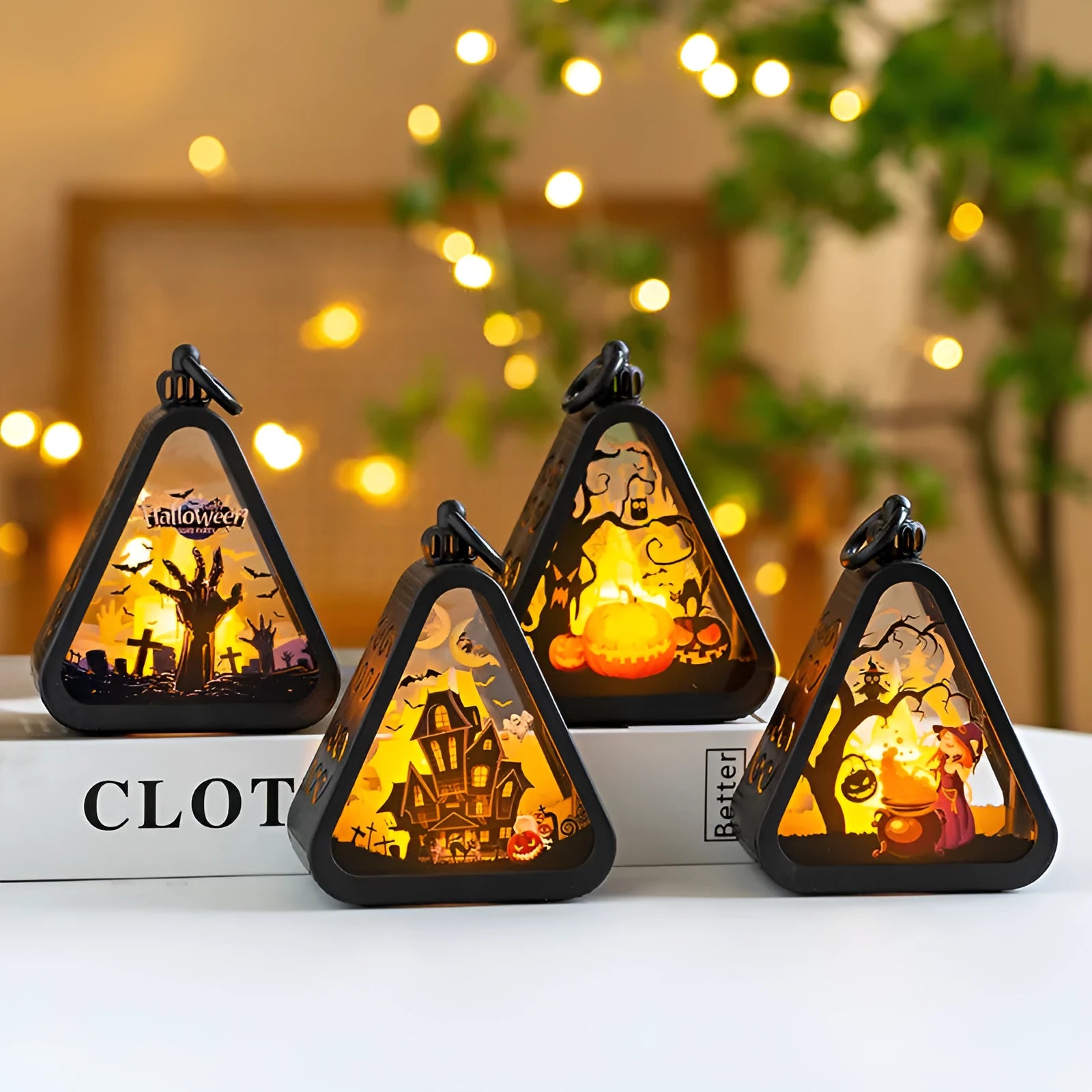 Halloween pumpkin lantern decoration in four colour designs on a table.