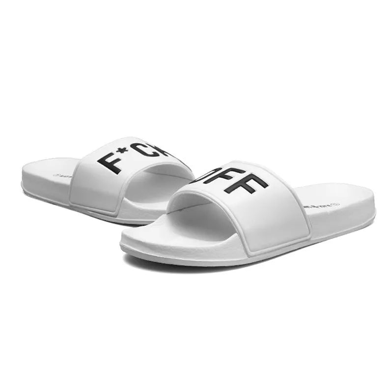 Large men's black and white open toe slippers with rubber soles on a plain background.