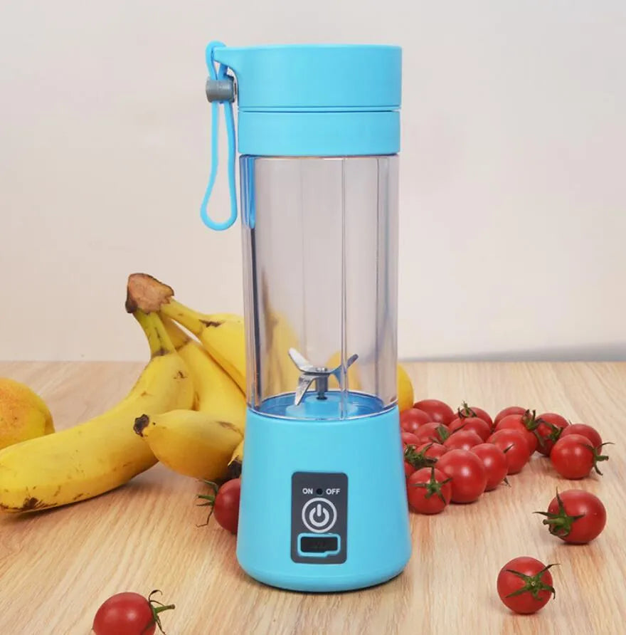 Mini USB-powered centrifugal fruit juicer in pink, with a 400ml plastic cup and stainless steel blade.