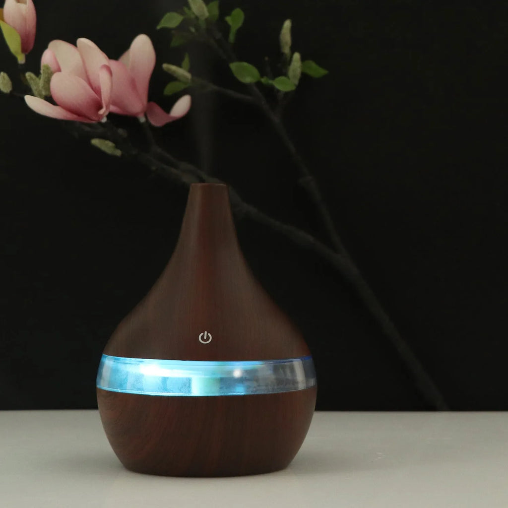 USB mini tip air purifier humidifier in wood grain, columnar shape, less than 1L tank, one fog outlet, 2-8 hour timer.