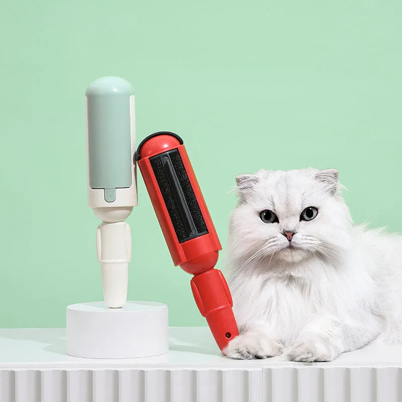 White green reusable pet hair remover roller with non-slip handle on a carpet.