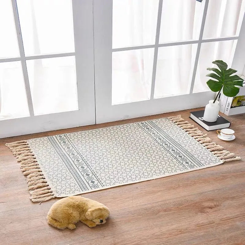 Handwoven cotton linen floor mat 60x90cm in ethnic style with natural plant dye, placed on a wooden floor