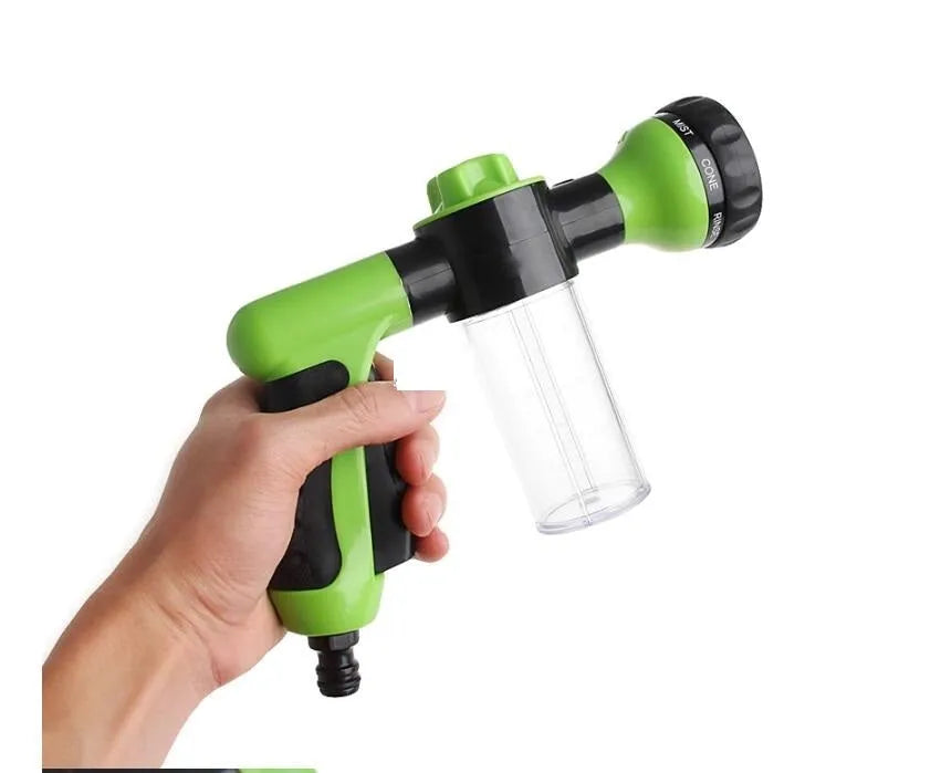 Green high-pressure foam spray gun for car washing with adjustable nozzle and attached water pipe.
