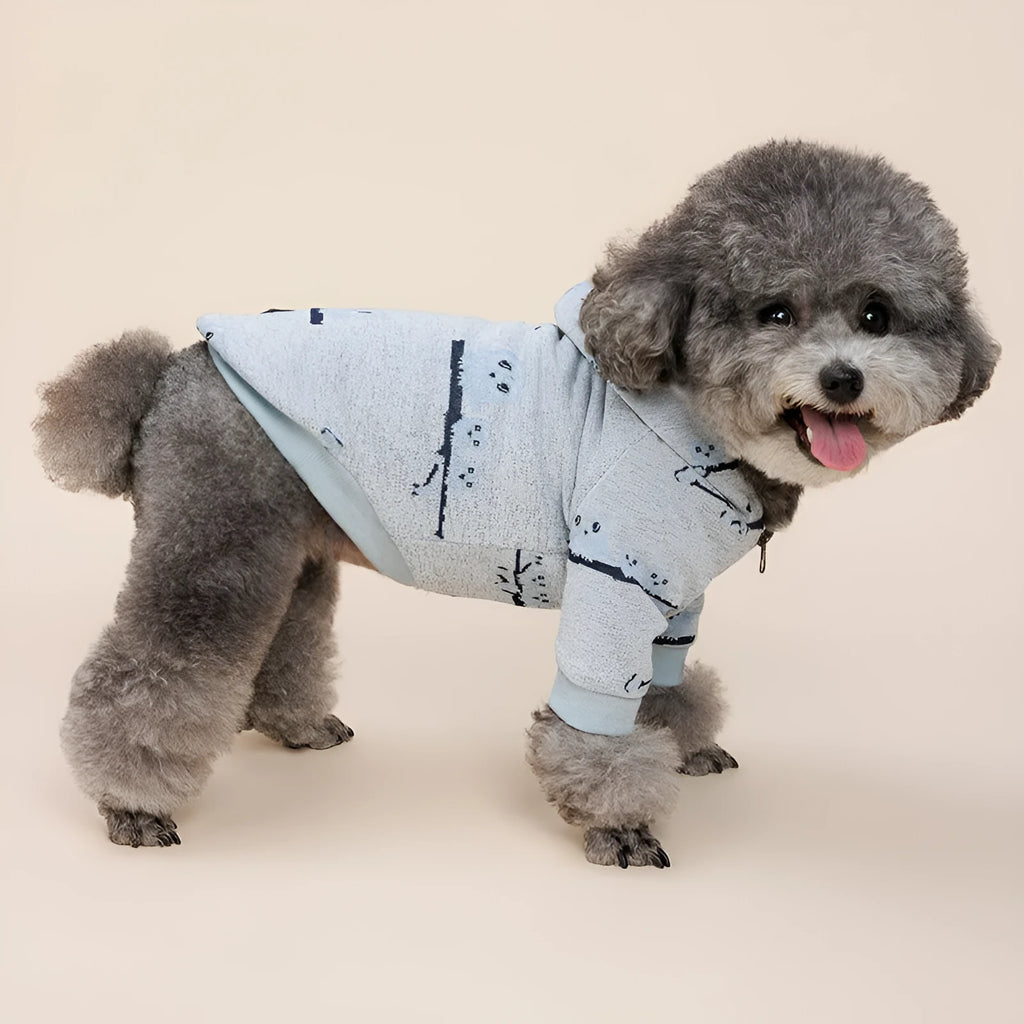 Blue cotton dog sweater with a front zip and animal print, shown on a model dog.