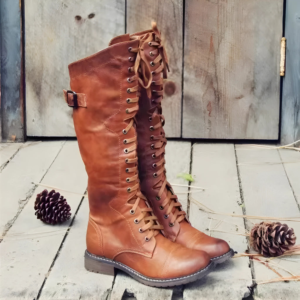 Women's black chunky heel high leg boots with a round toe and low profile.