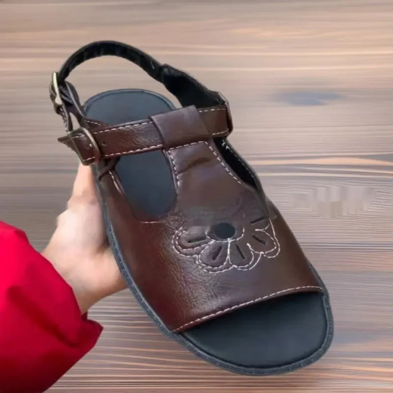 Men's black embroidered floral beach sandals with flat heel and PU upper.
