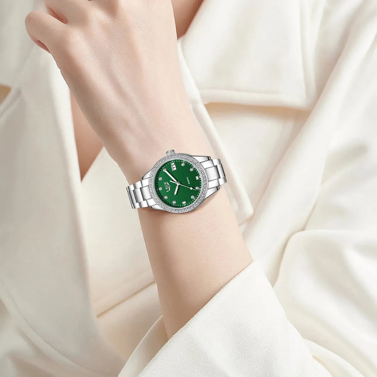Silver fashion quartz watch with diamond markers on a 34mm stainless steel case and luminous hands.