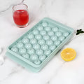 Blue silicone ice cube tray with lid showing 33 round cavities