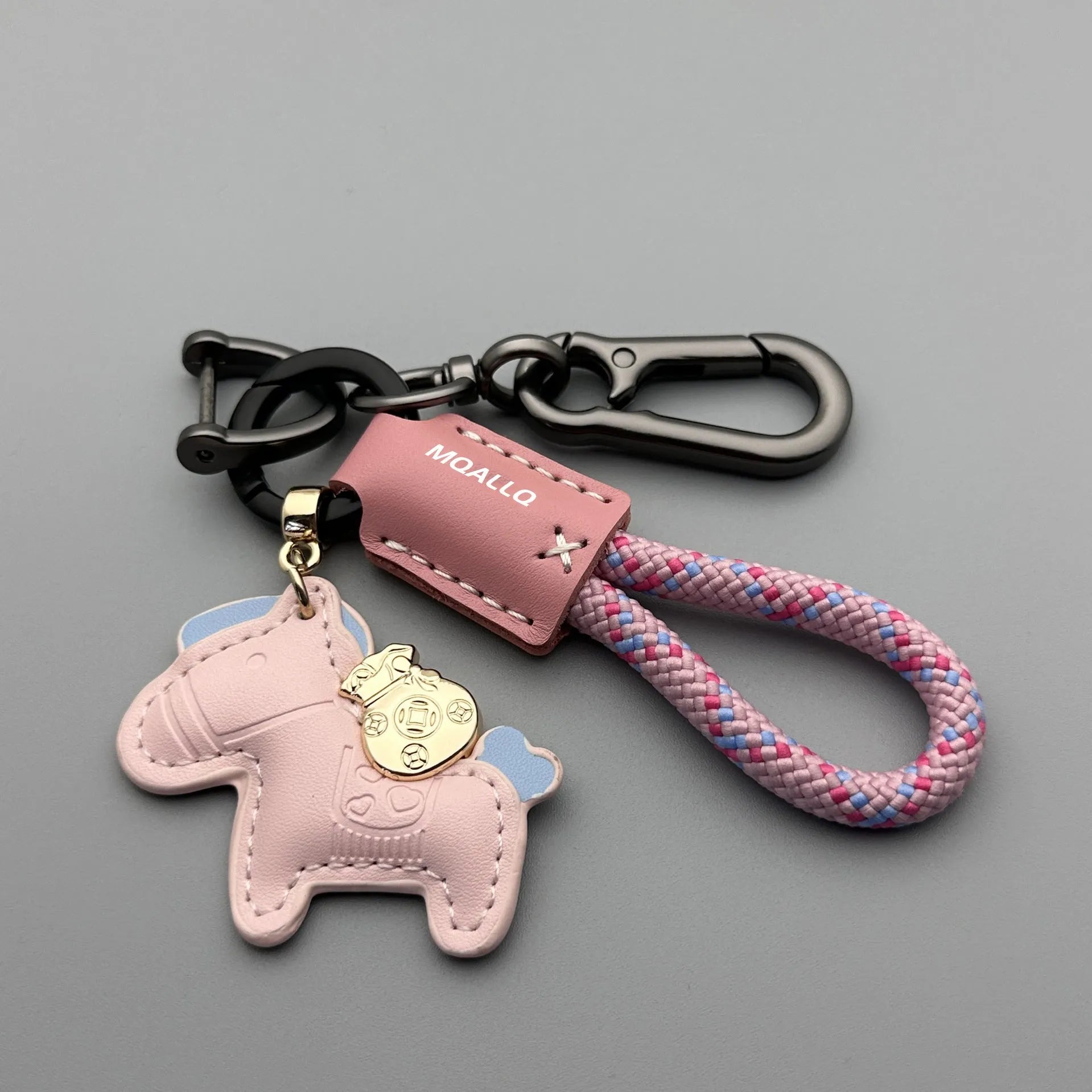 Handmade brown cowhide leather key ring with a zinc alloy pendant charm on a green flannel rope.