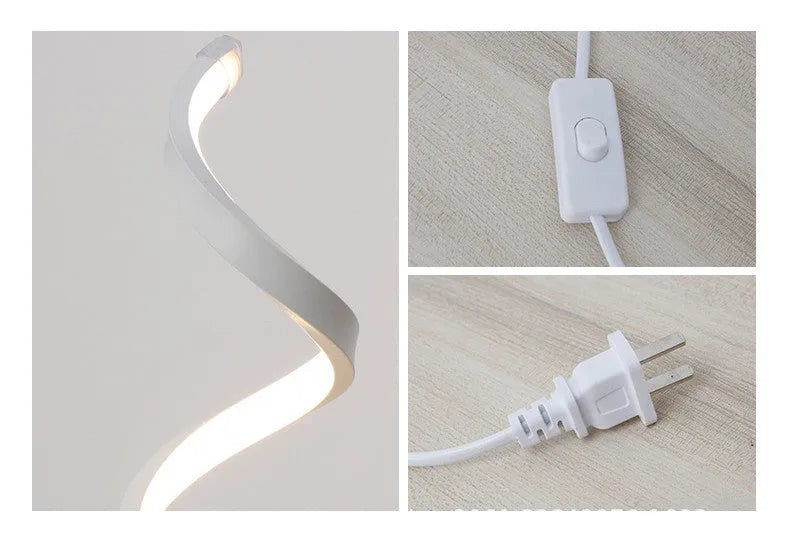 Modern LED table lamp with gold metal base and curved acrylic shade on a desk