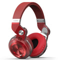 Black wireless Bluetooth headset with adjustable headband and over-ear cups on a grey background.