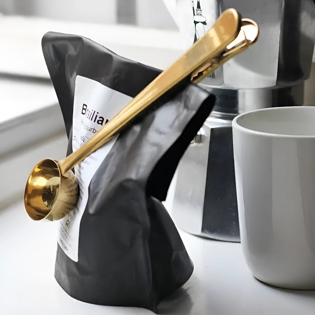 Silver stainless steel coffee scoop with integrated bag clip for measuring and sealing coffee bags