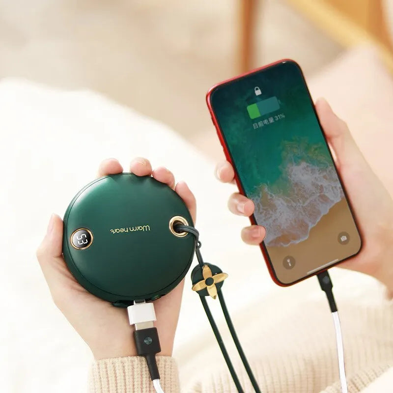 Green square hand warmer power bank with digital display showing charge level, next to a charging cable.