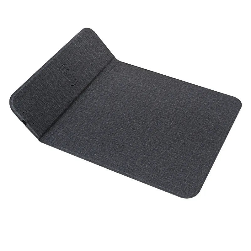 Black foldable fabric wireless charging phone holder standing upright on a desk.