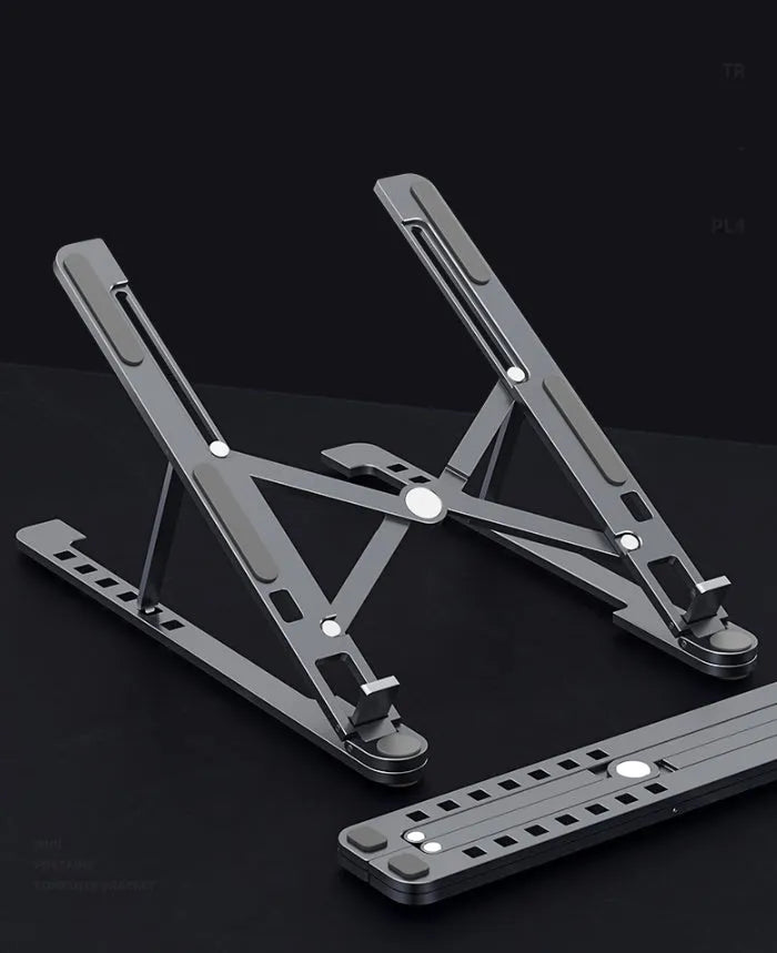 Silver aluminium folding laptop stand adjusted to medium height with a laptop in place.
