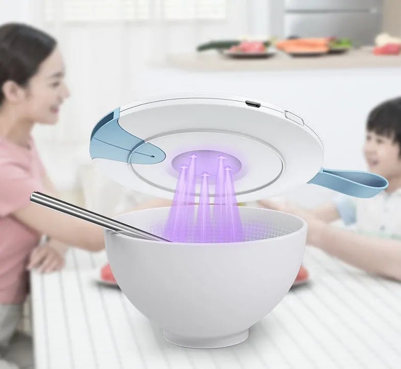 Slim blue portable UV baby bottle steriliser with USB port shown next to a baby bottle.