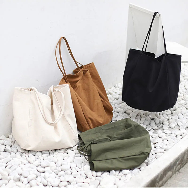 Large canvas shoulder tote bag in solid colour with soft handle, open top, and internal phone pocket