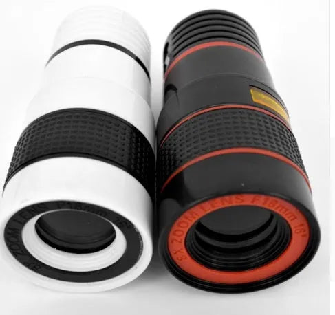 Black 12X smartphone telephoto lens with adjustable mounting clip and cleaning cloth on a table.
