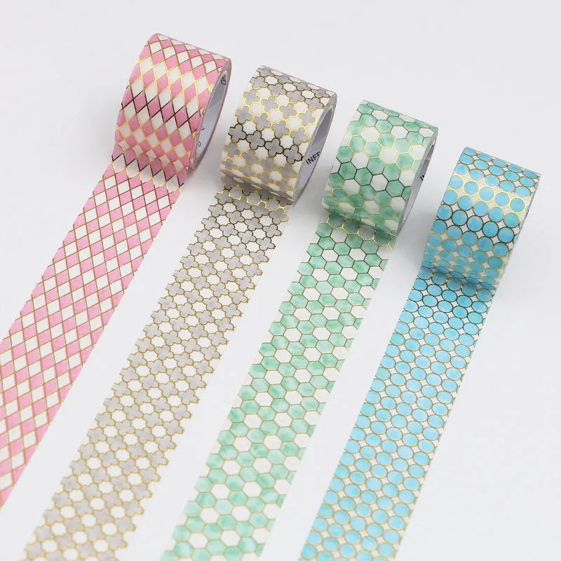 Roll of Alice in Wonderland themed decorative tape with a bronzed finish on Japanese paper, showing colour options.