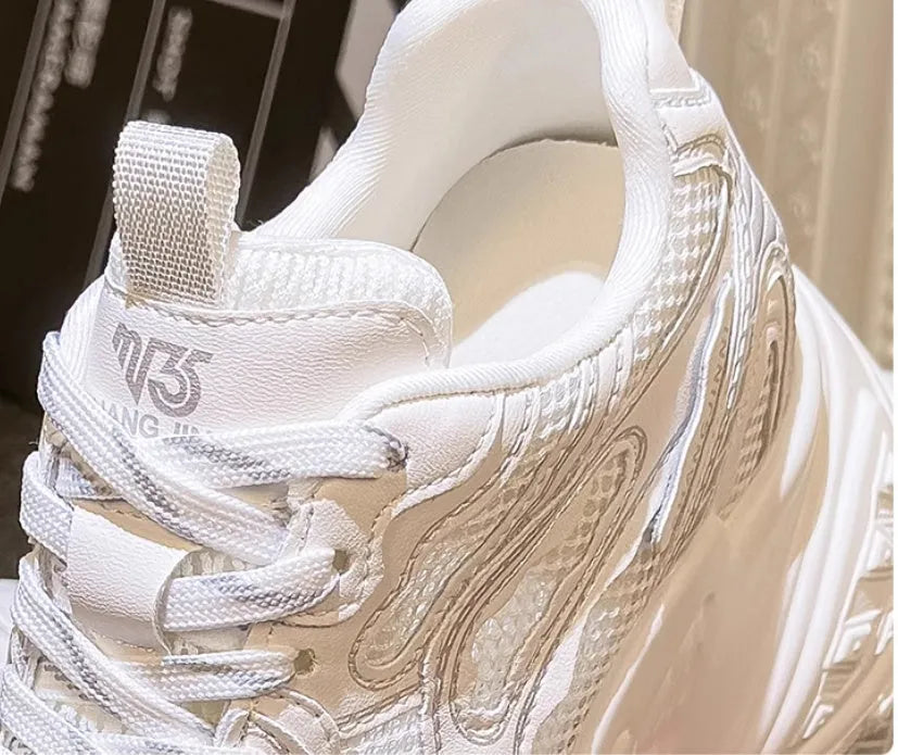 White women's lace-up dad shoes with a round toe and chunky sole for height increase.