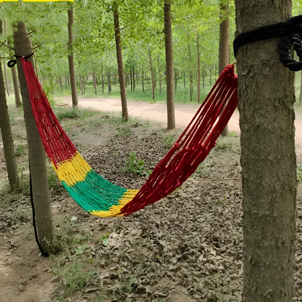 Outdoor bold style nylon rope mesh hammock shown in a garden setting