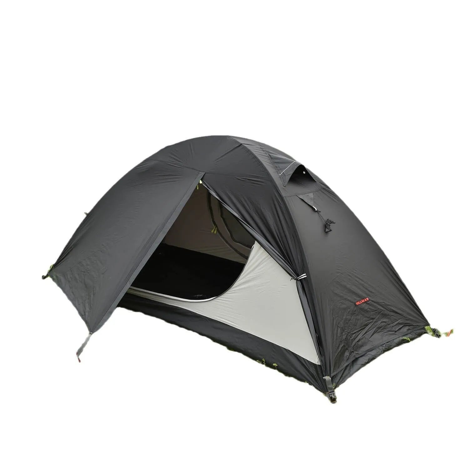 Red single-person double-layer backpacking tent with aluminium poles pitched in a grassy field