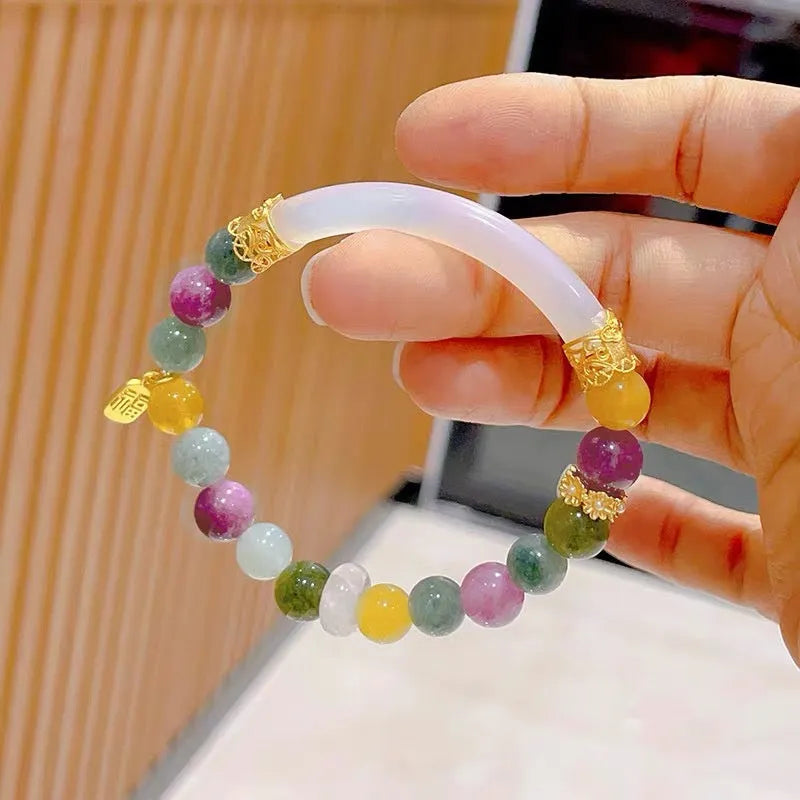 Women's rainbow tourmaline half bracelet with electroplated finish showing natural stone colour variations