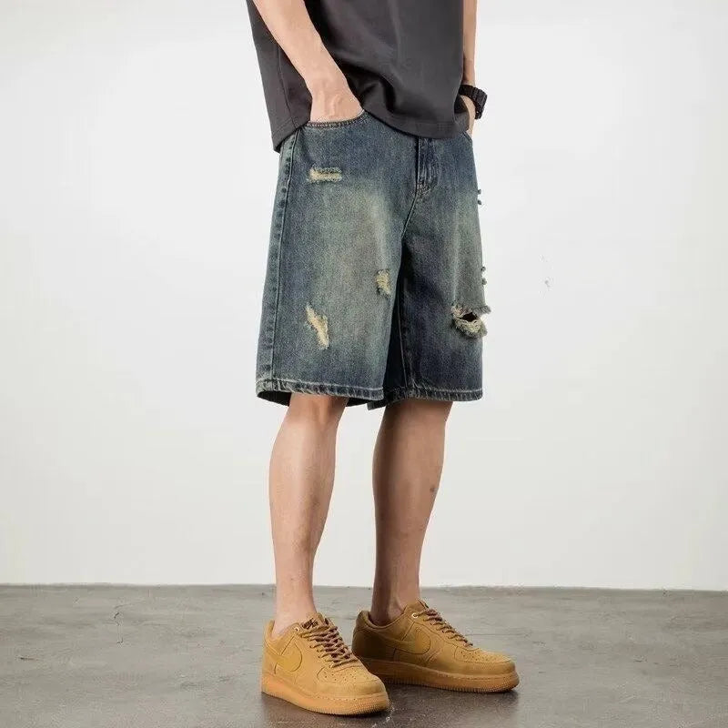 Blue retro loose-fit men's denim shorts with distressed holes and a straight-leg cut