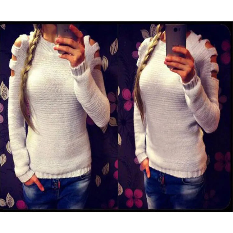 White women's knitted long sleeve shirt with hollow-out crochet detail on a hanger.