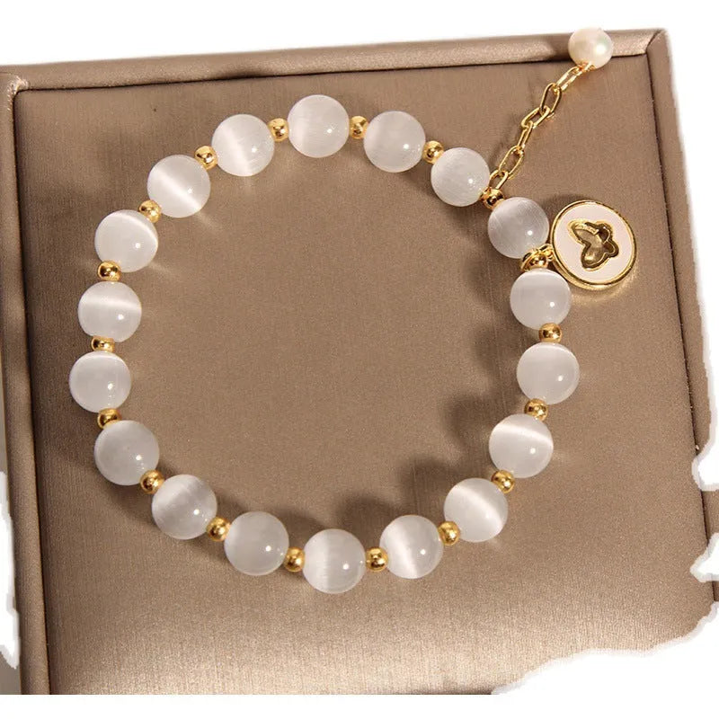 White cat's eye crystal bracelet with geometric design on a wrist