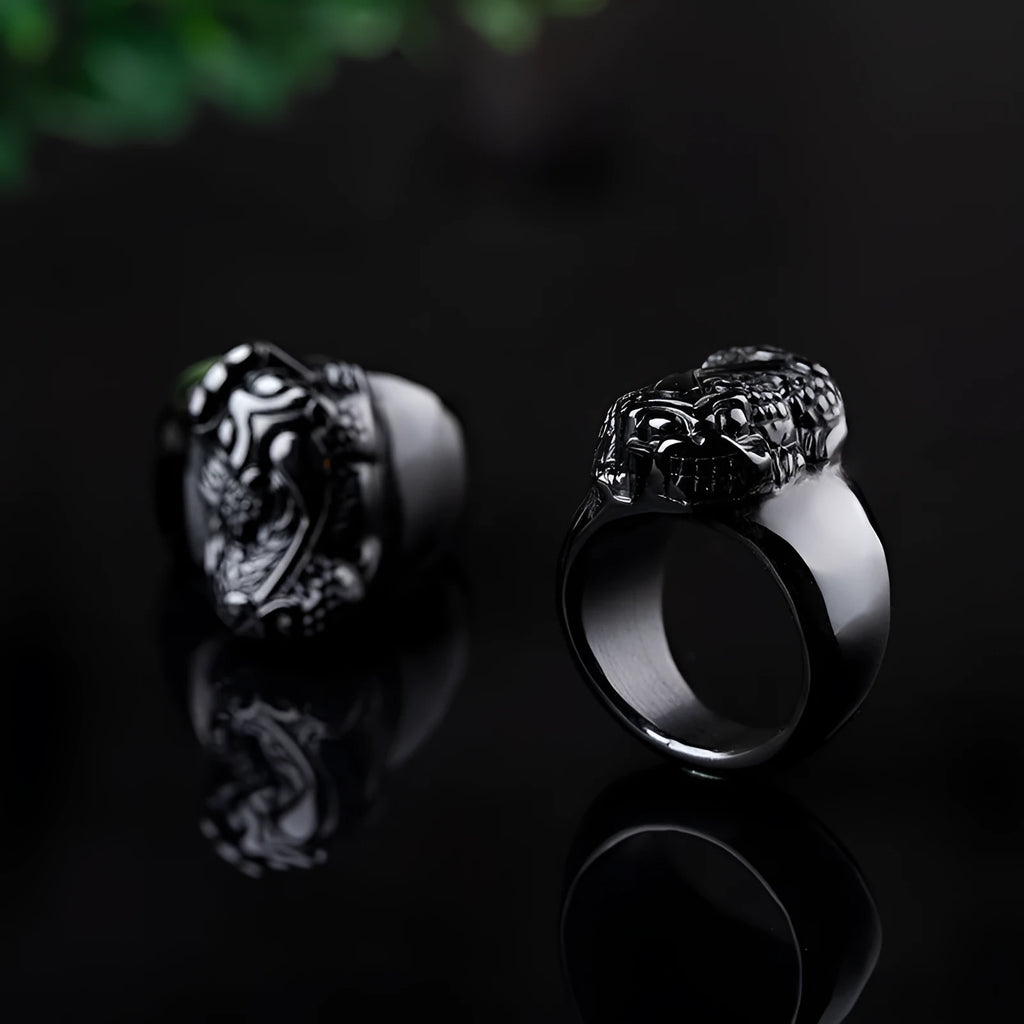 Men's black obsidian Pixiu thumb ring with gold sheen on an alloy band, showing side profile.