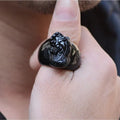 Men's black obsidian Pixiu thumb ring with gold sheen on an alloy band, showing side profile.