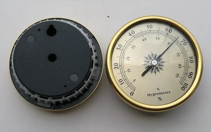 Analog thermometer and hygrometer with silver aluminium ring and dial showing temperature and humidity scales.
