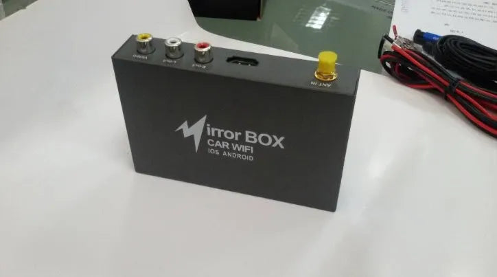 Black car mirror link box with Wi-Fi converter, power cable, antenna, AV cable, and user manual.