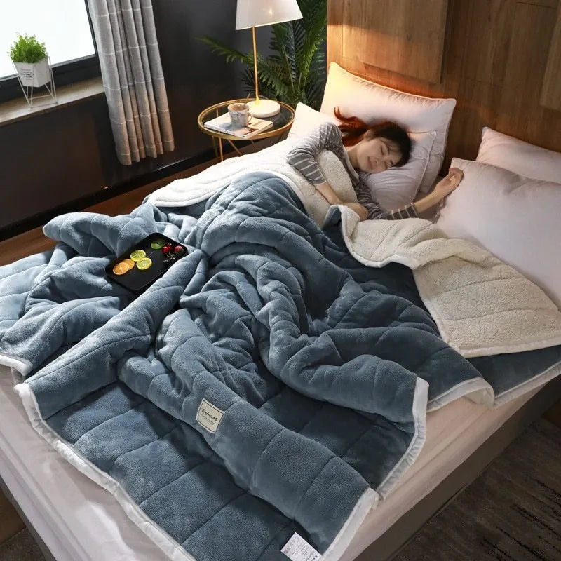 Thick coral fleece winter blanket in a solid colour, shown on a bed, dimensions 150cm by 200cm.