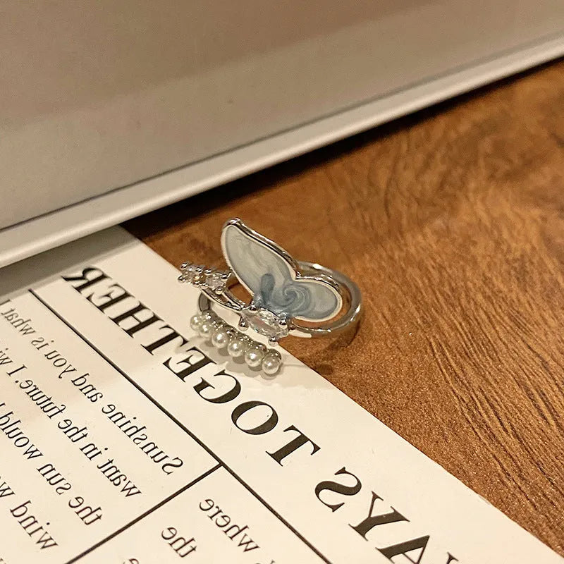 Creative butterfly design women's ring in copper with oil drip finish, showing an open loop style.