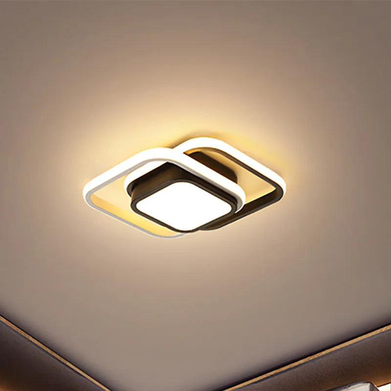 Modern round aluminium ceiling light with integrated LEDs, shown illuminating an entrance hall.