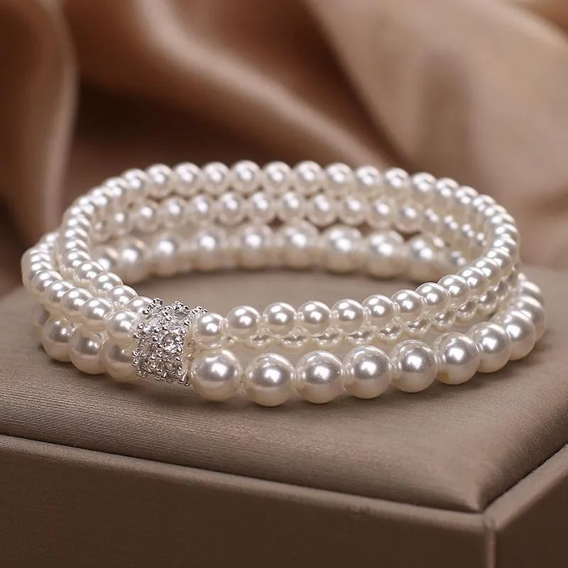 Baroque pearl multi-layer twin bracelet with pink and white imitation pearl beads on display