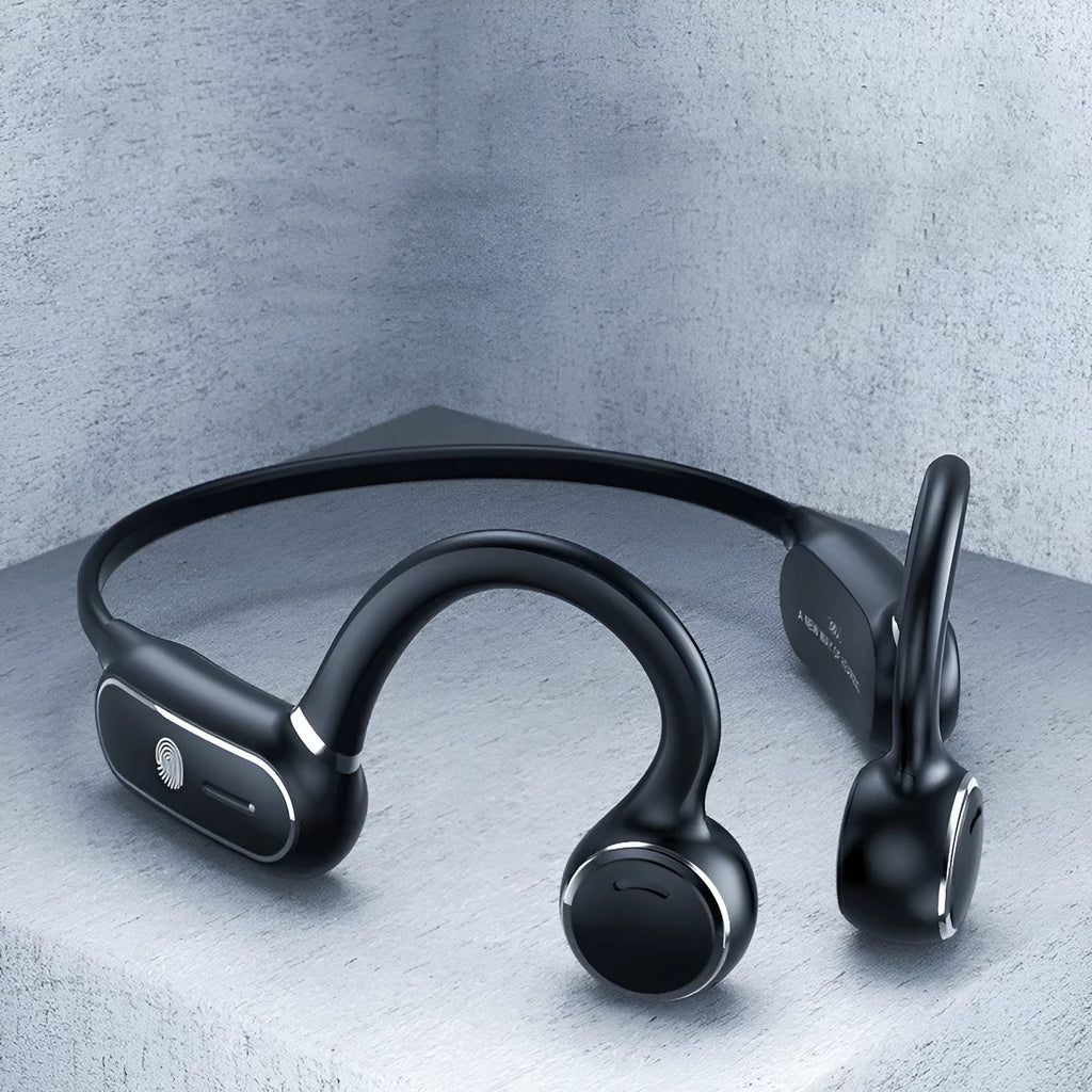 Black air conduction Bluetooth wireless earphone with titanium wire frame shown hanging over a pair of glasses.