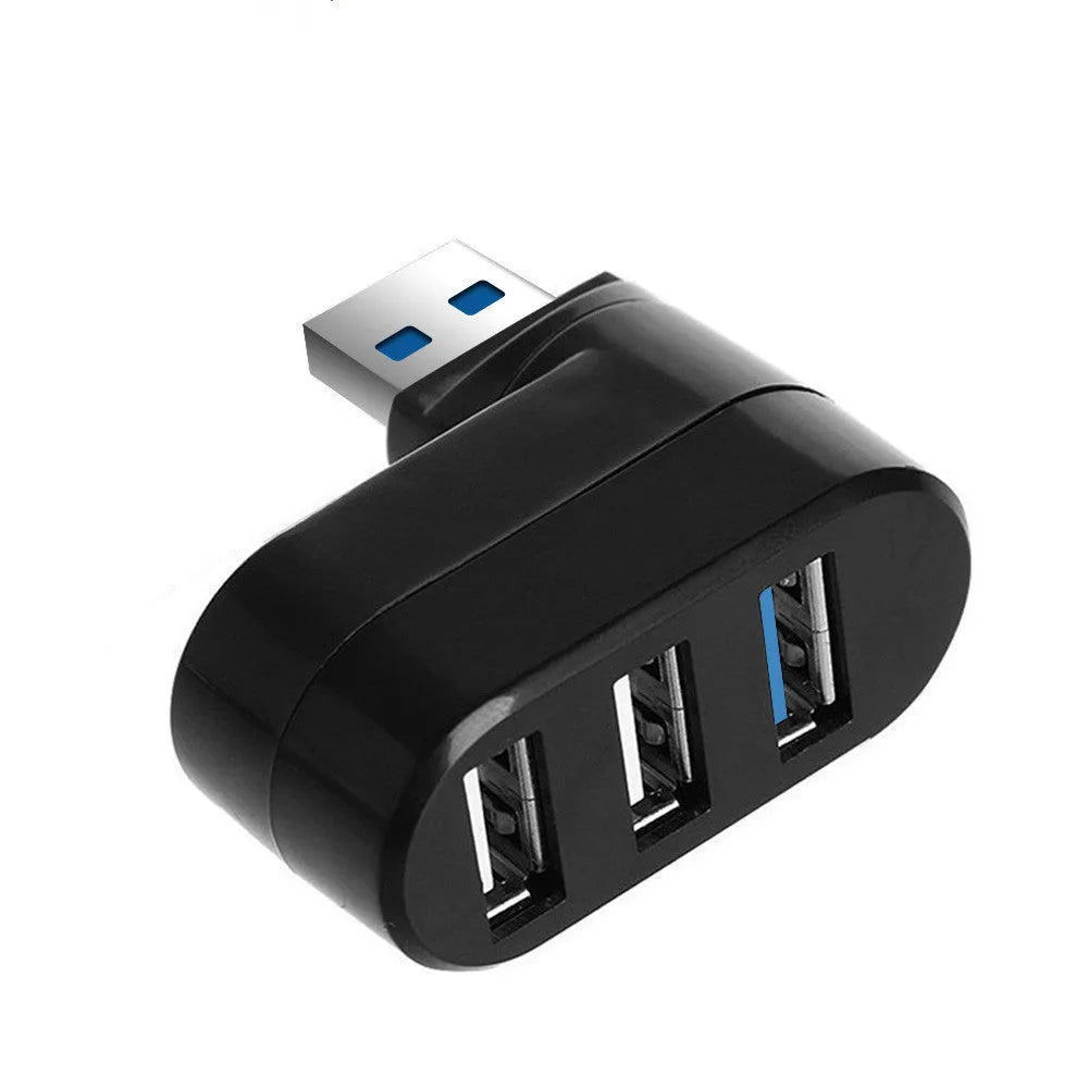 Black USB 3.0 four-port rotary hub on a desk next to a laptop, showing its compact size and rotating design.