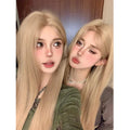 Full hair type women's long straight gray gold wig in milk tea blonde with hairnet on a mannequin