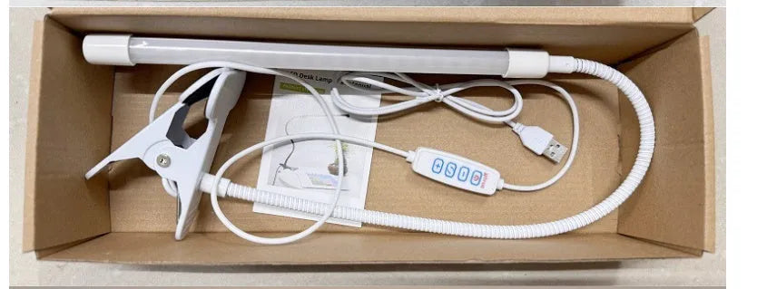 Black and white USB-powered LED desk lamp with flexible 26 cm gooseneck neck on a desk.