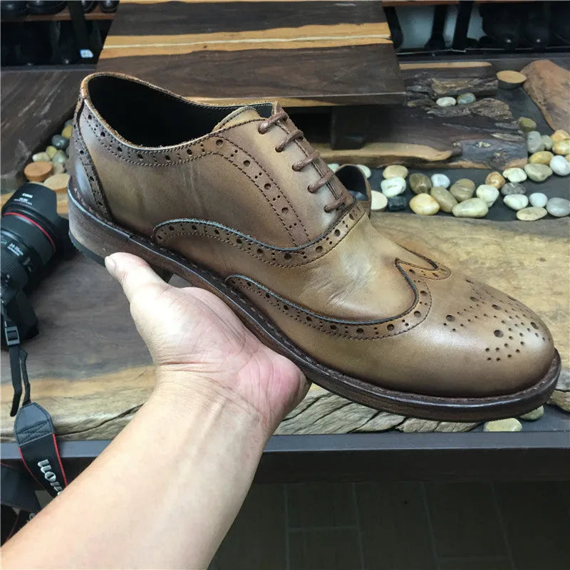 Men's light brown vintage distressed leather shoes with engraved detailing and round toe.
